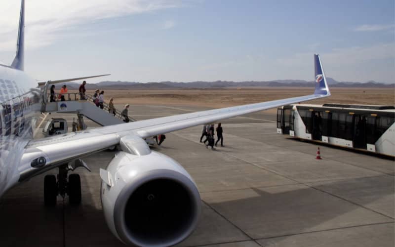 Moroccan Travelers Face COVID Risk in Crowded Airport Shuttle at Malaga